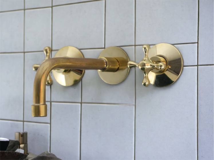 Handcrafted brass wall-mounted basin mixer